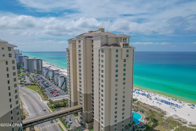 view of property with a water view and a view of the beach