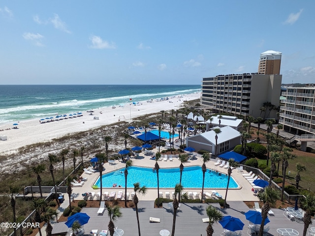 birds eye view of property with a water view and a view of the beach