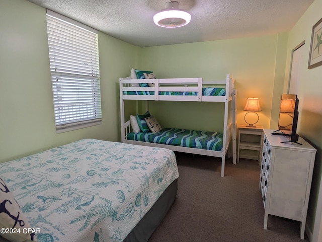 carpeted bedroom featuring a textured ceiling