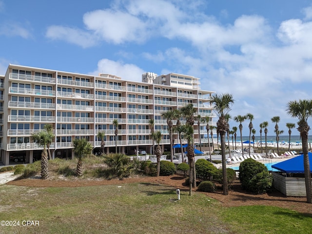 view of property featuring a water view and a view of the beach