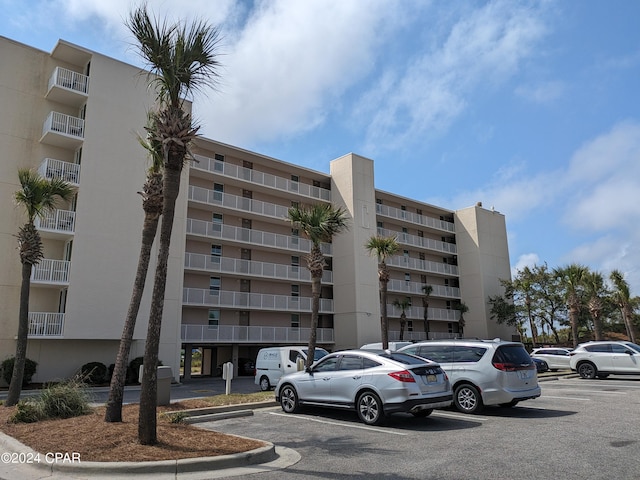 view of property featuring uncovered parking