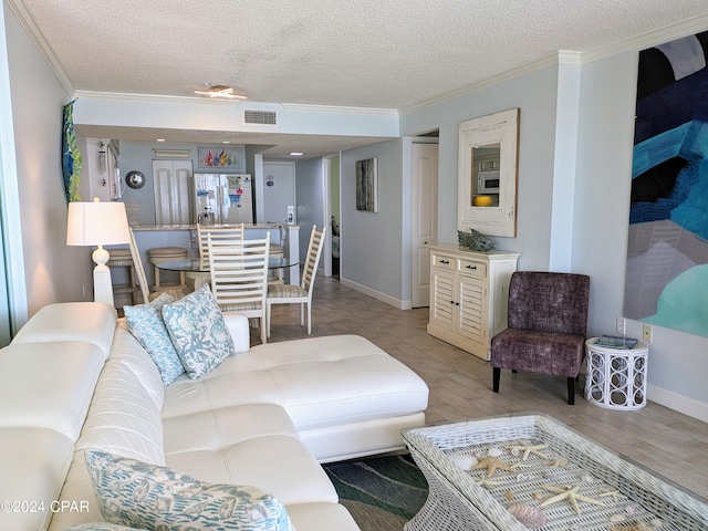 living room with a textured ceiling and crown molding