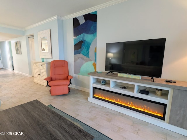 sitting room with ornamental molding, a glass covered fireplace, and baseboards