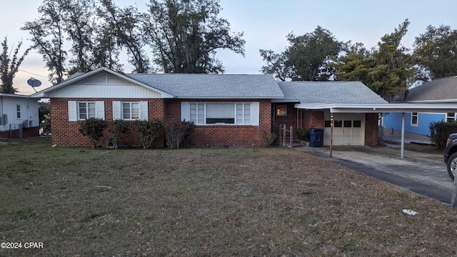 single story home with a yard and a carport