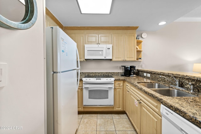 kitchen with white appliances, dark stone countertops, sink, and light brown cabinets