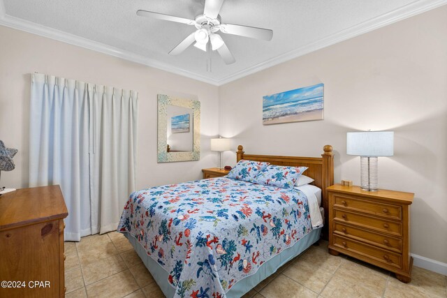 tiled bedroom featuring ceiling fan, ornamental molding, and a textured ceiling