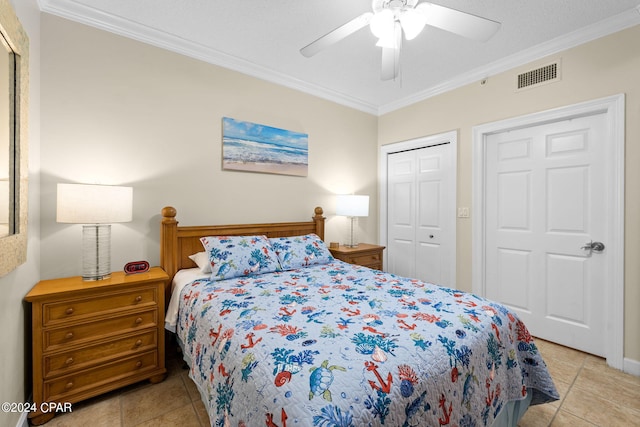 bedroom with crown molding, a closet, and light tile patterned flooring