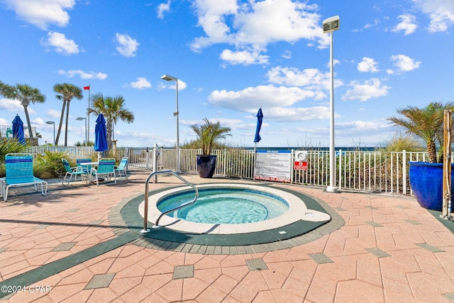 view of pool featuring a community hot tub and a patio