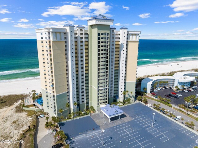 birds eye view of property with a water view and a view of the beach