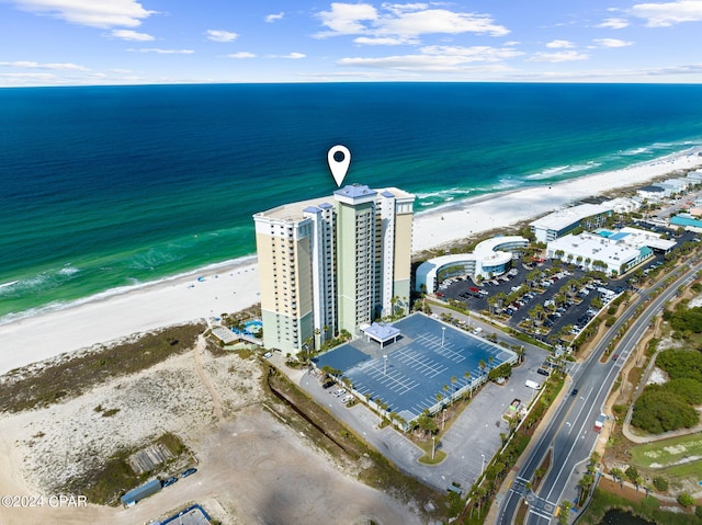 drone / aerial view with a water view and a beach view