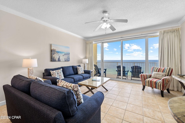 tiled living room featuring ornamental molding, a water view, and a textured ceiling