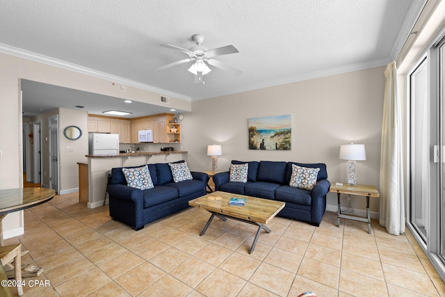 living room featuring light tile patterned flooring, ceiling fan, a textured ceiling, and crown molding