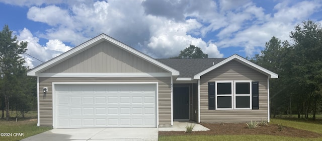 view of front of home with a lawn and a garage