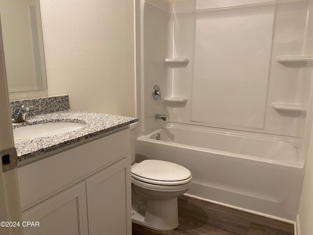 full bathroom featuring vanity, toilet, wood-type flooring, and shower / washtub combination