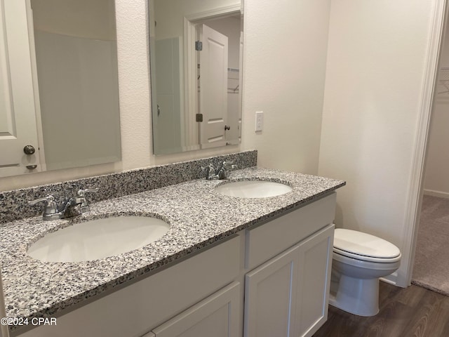 bathroom featuring vanity, toilet, and hardwood / wood-style floors