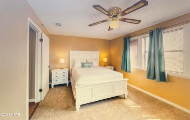 carpeted bedroom with ceiling fan