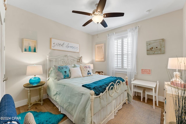 bedroom with hardwood / wood-style floors and ceiling fan