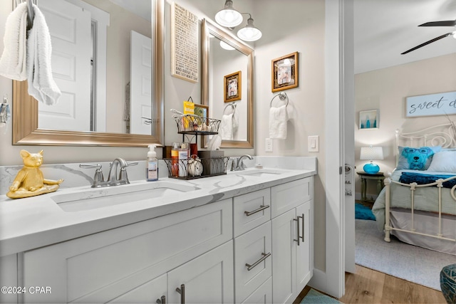 bathroom featuring hardwood / wood-style floors, ceiling fan, and dual vanity