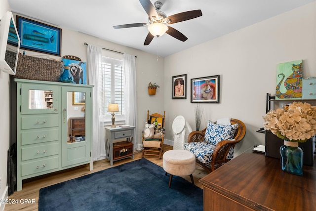 sitting room featuring ceiling fan and hardwood / wood-style floors