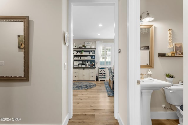 bathroom featuring wood-type flooring and toilet