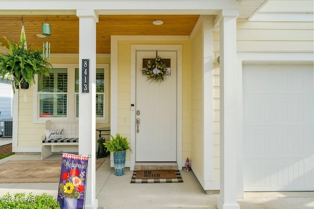 property entrance with a garage and covered porch