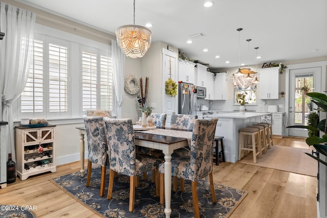 dining room featuring light hardwood / wood-style flooring and a notable chandelier