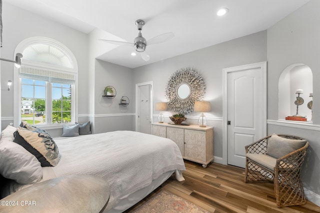 bedroom with wood-type flooring and ceiling fan