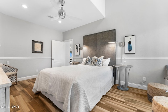 bedroom with ceiling fan and wood-type flooring