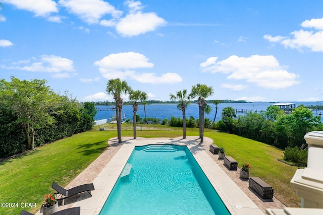 view of pool with a lawn and a water view