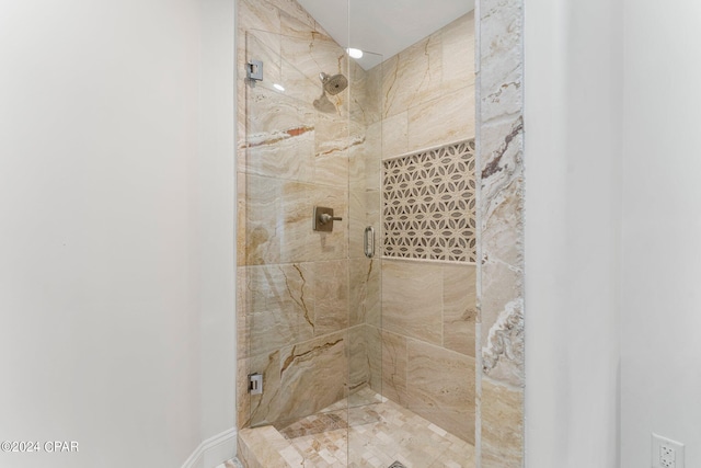 bathroom with a shower with shower door