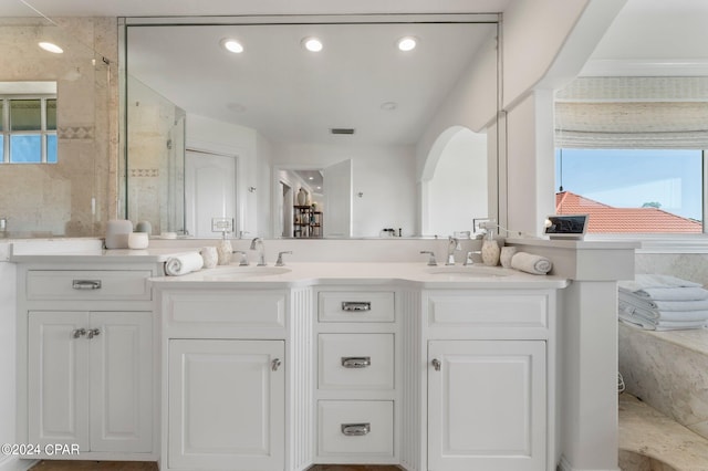 bathroom with a wealth of natural light and double vanity