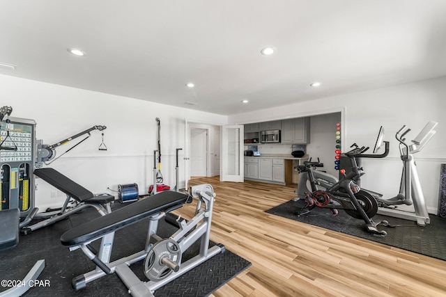 exercise area featuring light hardwood / wood-style floors