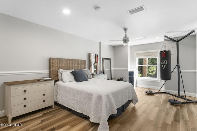 bedroom with ceiling fan and hardwood / wood-style flooring