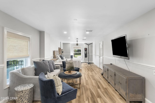 living room with plenty of natural light and light hardwood / wood-style flooring