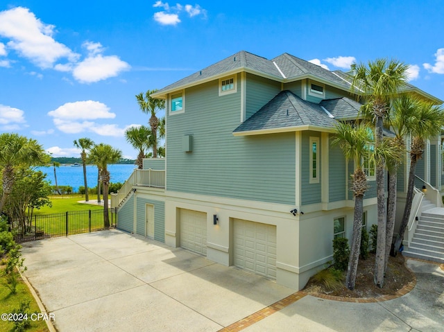 view of side of home with a garage and a water view