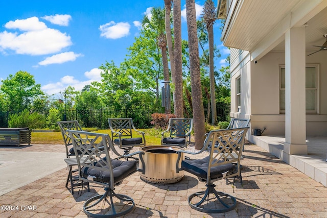 view of patio / terrace with an outdoor fire pit and ceiling fan