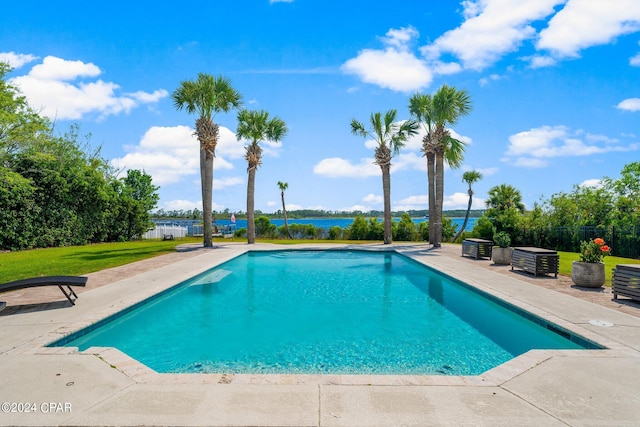 view of pool featuring a lawn