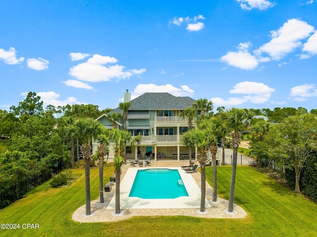 view of pool with a patio and a yard