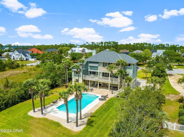 view of pool featuring a patio area and a yard