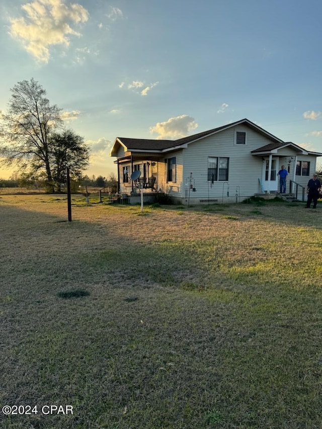 view of front of property with crawl space and a front yard