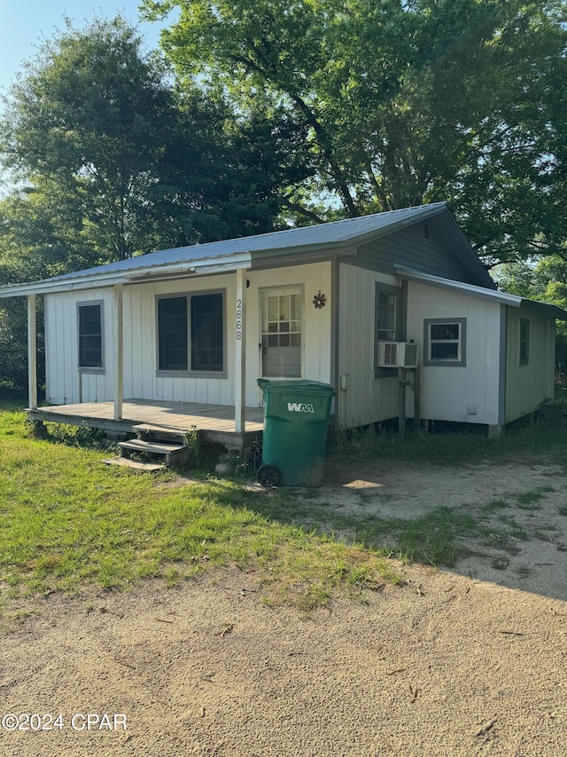 view of front facade with cooling unit and covered porch