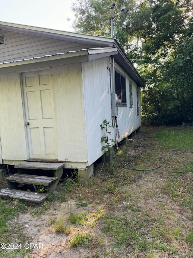 view of side of home featuring entry steps