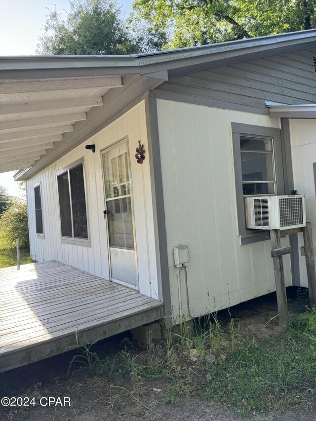 view of home's exterior featuring a wooden deck and cooling unit