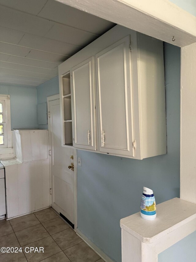 clothes washing area featuring light tile patterned floors