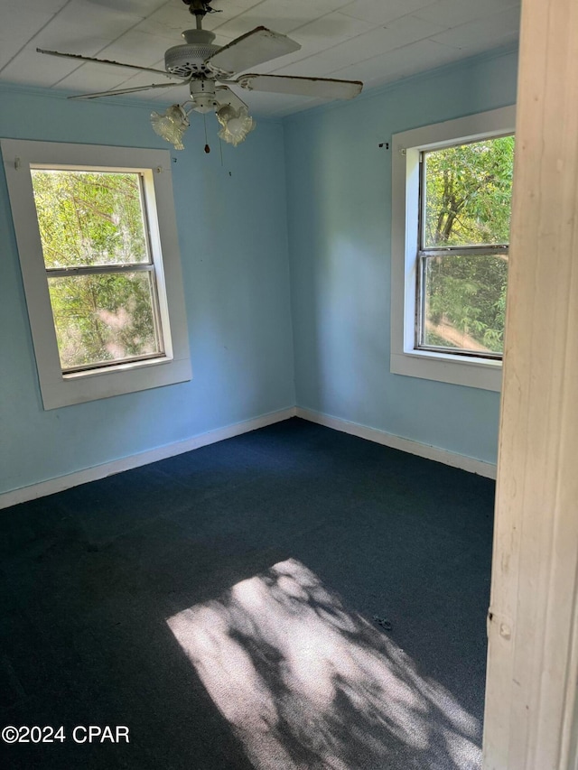 carpeted empty room featuring ceiling fan