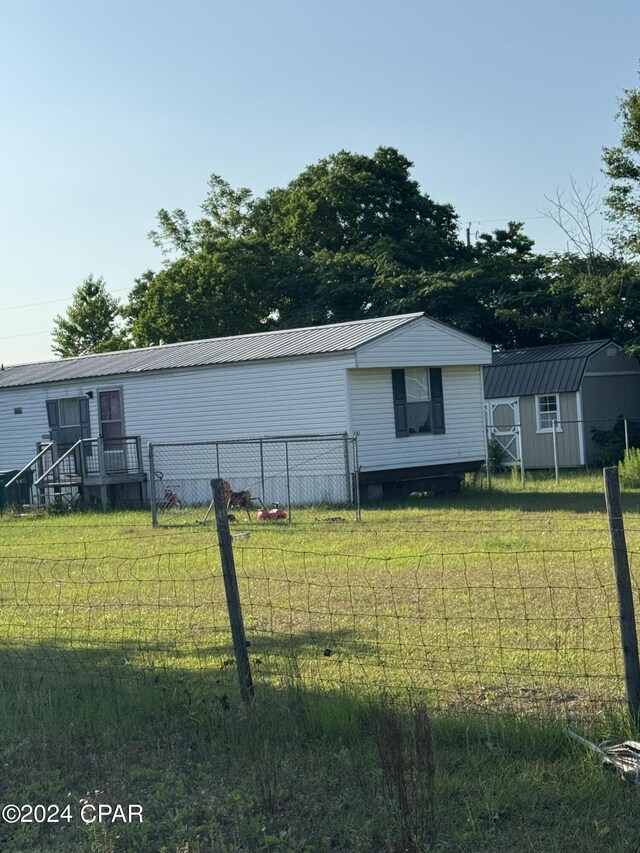 exterior space with a shed and a lawn