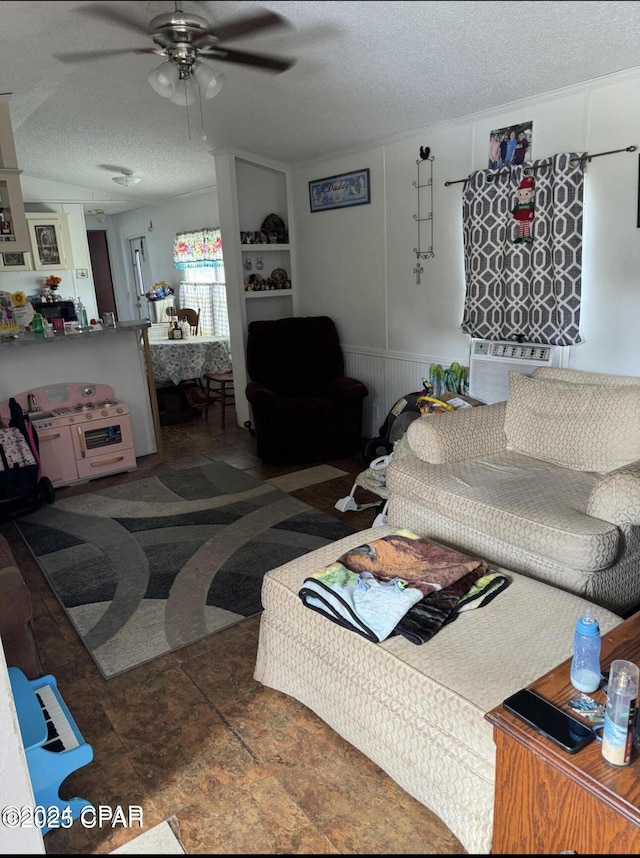 living room with a textured ceiling and a ceiling fan