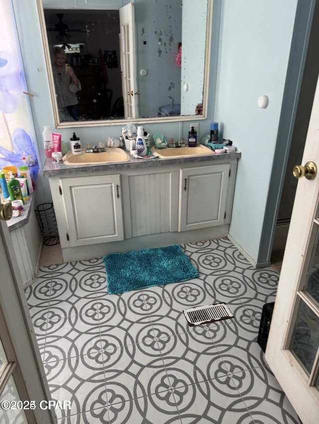 bathroom featuring double vanity, tile patterned flooring, and a sink