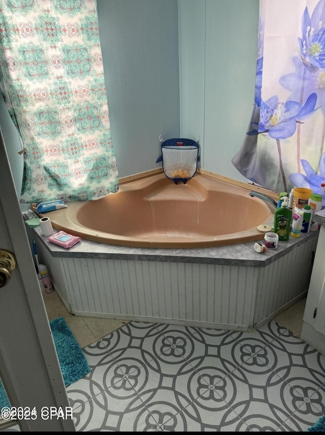 full bathroom featuring a tub to relax in and tile patterned floors