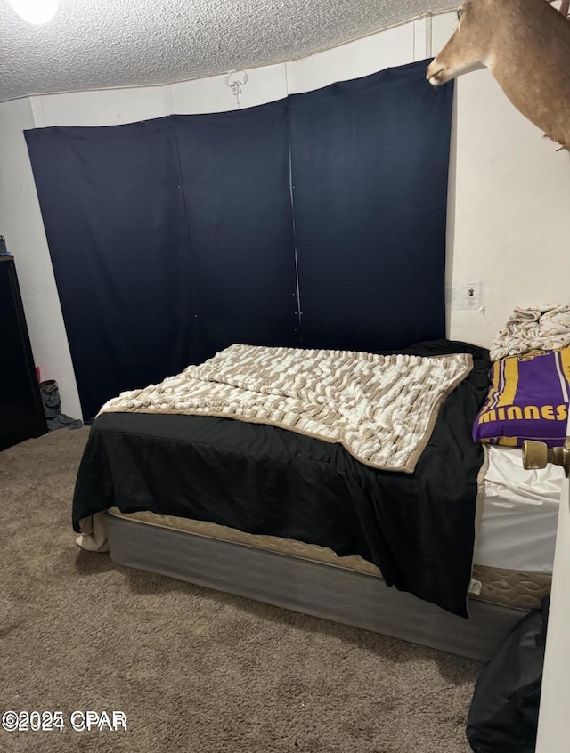 carpeted bedroom with a textured ceiling